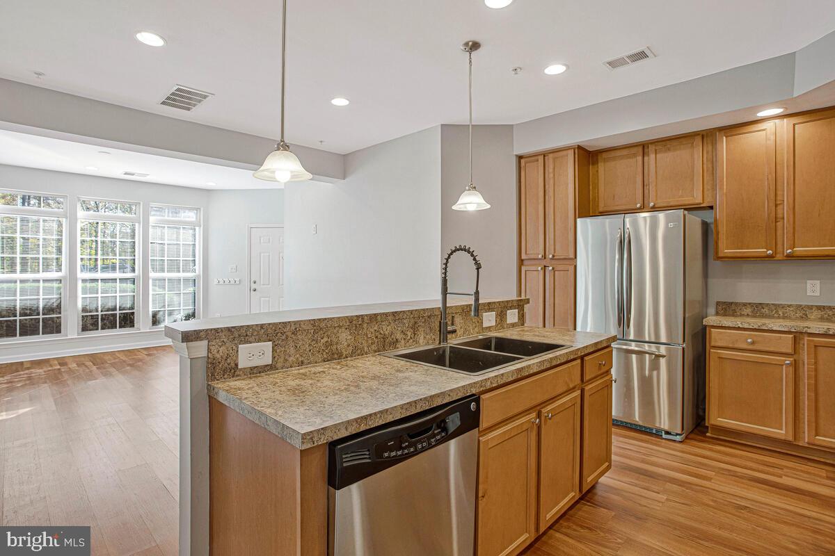 8049 Forest Ridge Drive, Unit 3 Chesapeake Beach, MD 20732 - Photo 12 of 40 a kitchen with stainless steel appliances granite countertop a sink a stove and a refrigerator