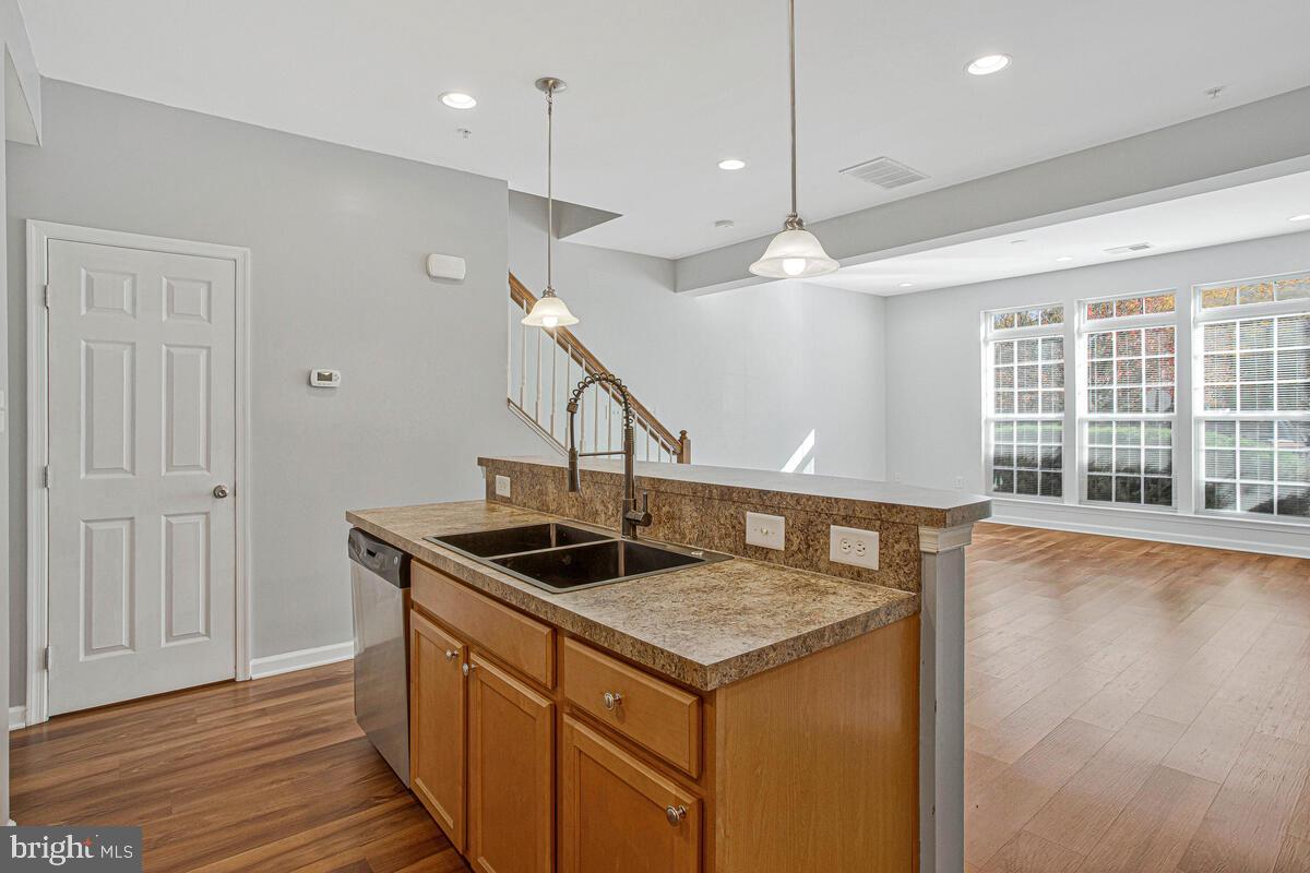 8049 Forest Ridge Drive, Unit 3 Chesapeake Beach, MD 20732 - Photo 13 of 40 a kitchen with a stove and a sink