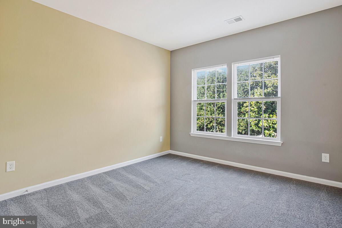 8049 Forest Ridge Drive, Unit 3 Chesapeake Beach, MD 20732 - Photo 18 of 40 an empty room with a window
