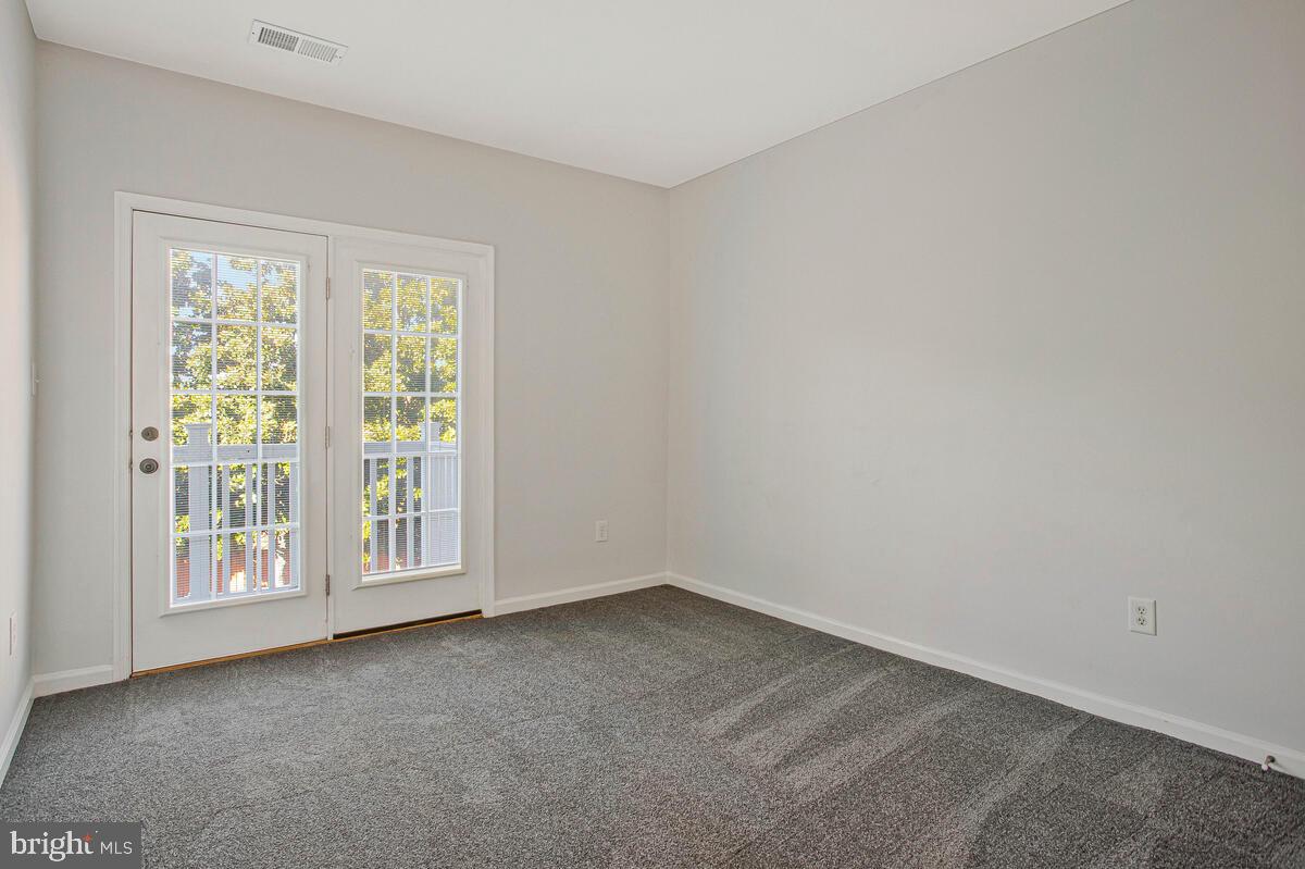 8049 Forest Ridge Drive, Unit 3 Chesapeake Beach, MD 20732 - Photo 20 of 40 an empty room with a window