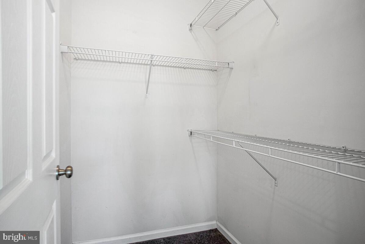 8049 Forest Ridge Drive, Unit 3 Chesapeake Beach, MD 20732 - Photo 21 of 40 a view of a room with racks on the wall