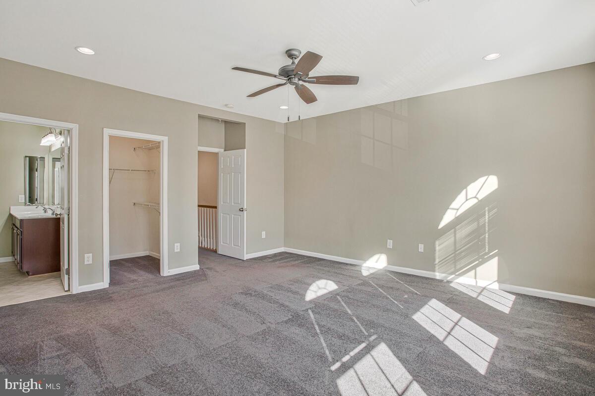 8049 Forest Ridge Drive, Unit 3 Chesapeake Beach, MD 20732 - Photo 25 of 40 a view of a big room with windows and ceiling fan