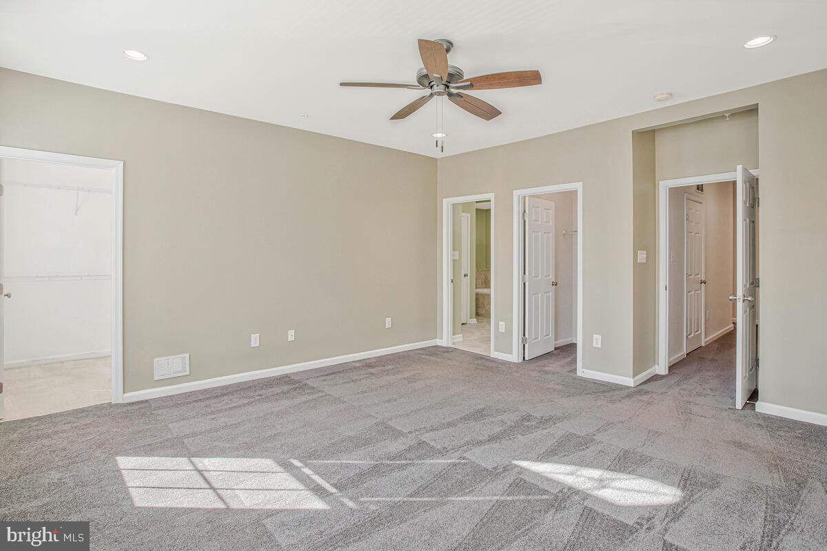 8049 Forest Ridge Drive, Unit 3 Chesapeake Beach, MD 20732 - Photo 26 of 40 a view of a livingroom with a ceiling fan and window
