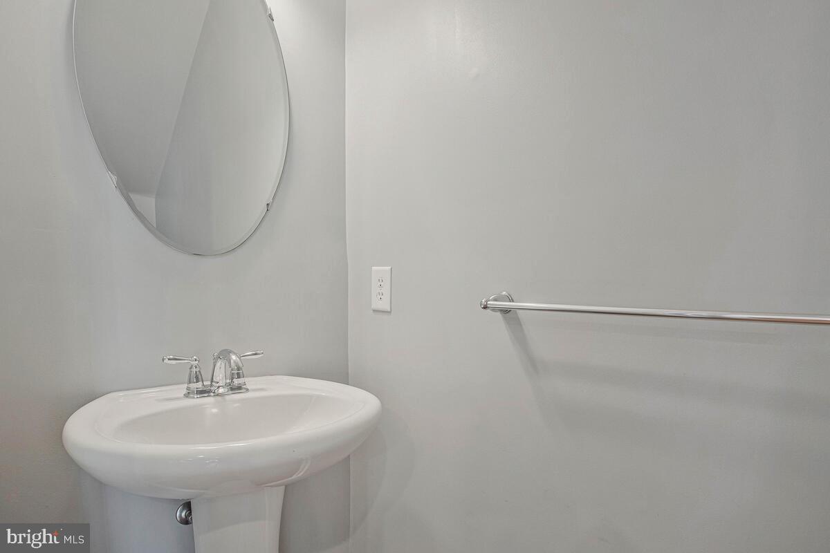 8049 Forest Ridge Drive, Unit 3 Chesapeake Beach, MD 20732 - Photo 28 of 40 a bathroom with a sink a shower and a mirror