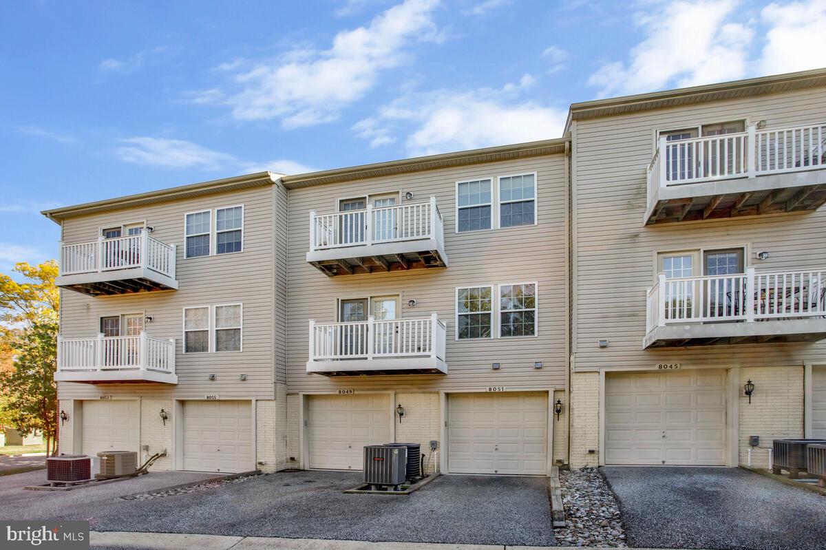 8049 Forest Ridge Drive, Unit 3 Chesapeake Beach, MD 20732 - Photo 4 of 40 a front view of a building with glass windows