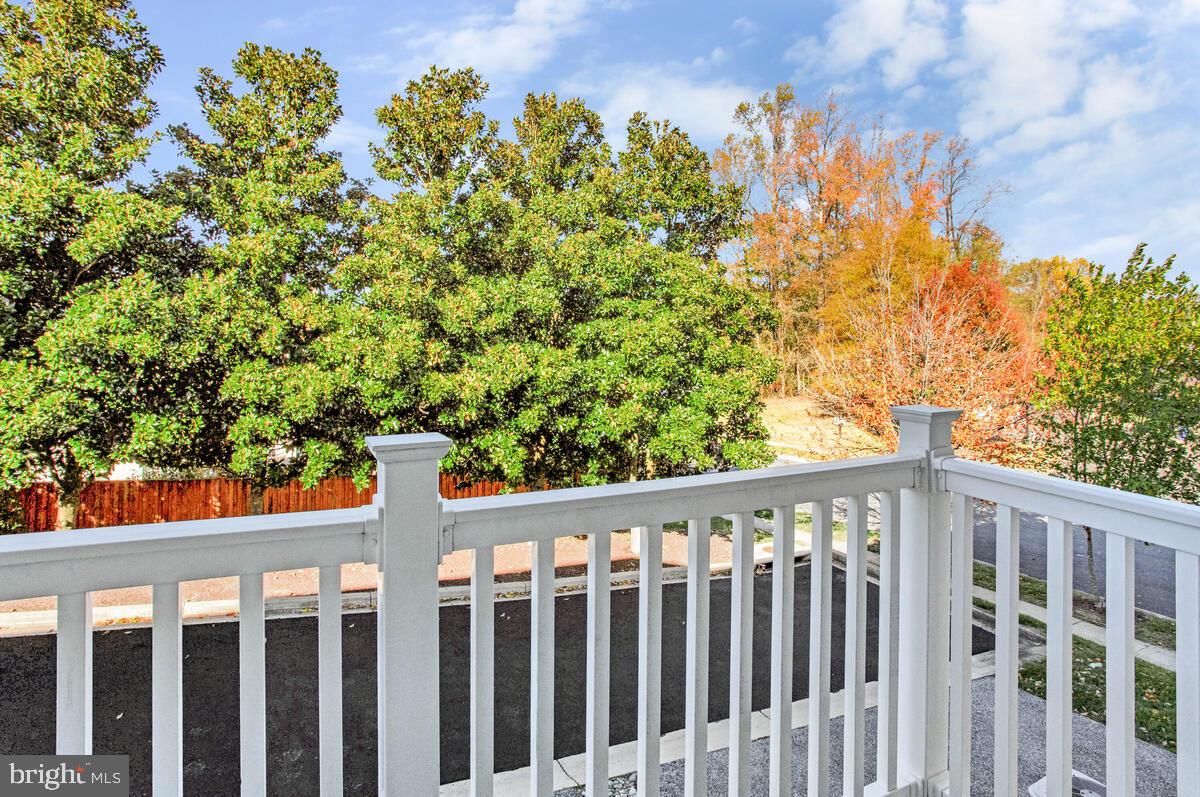 8049 Forest Ridge Drive, Unit 3 Chesapeake Beach, MD 20732 - Photo 6 of 40 a wooden fence with trees in the background