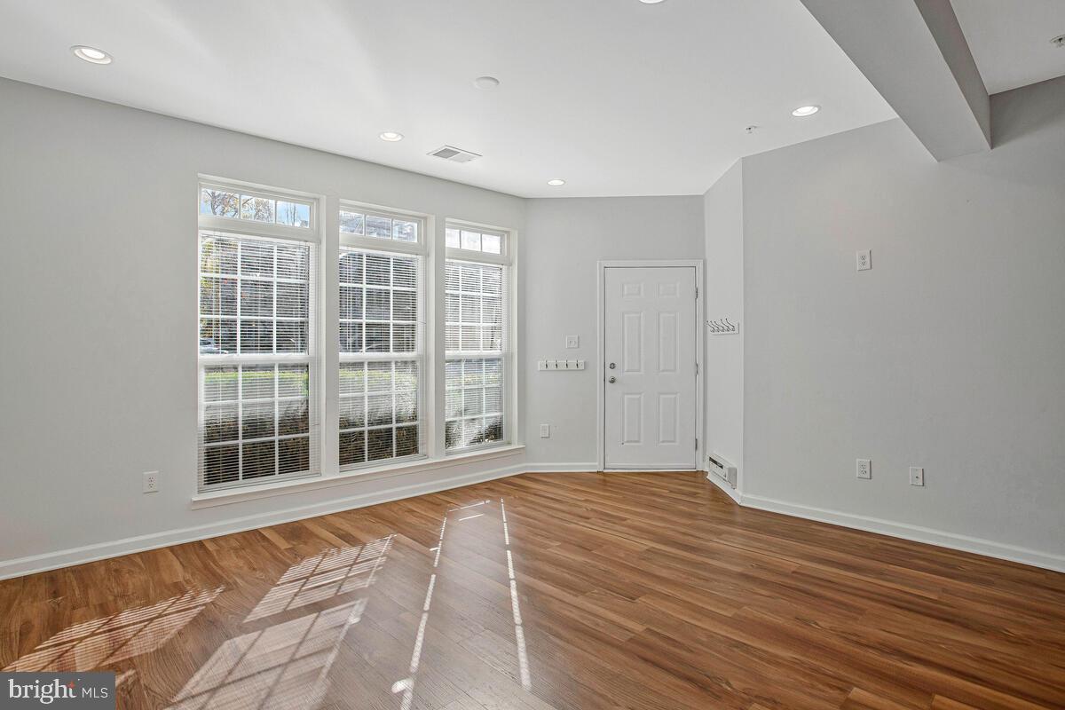 8049 Forest Ridge Drive, Unit 3 Chesapeake Beach, MD 20732 - Photo 10 of 40 a view of empty room with wooden floor and fan