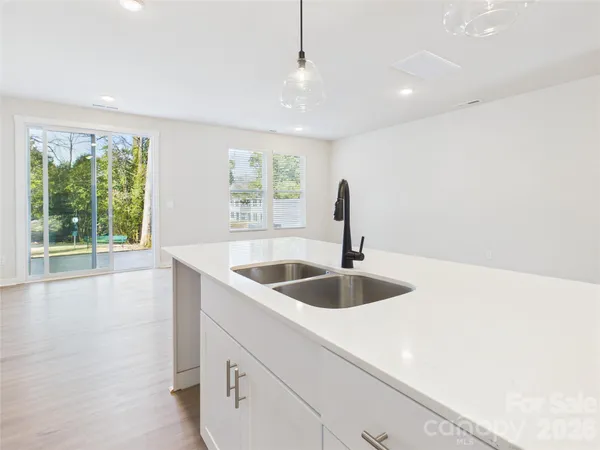 a kitchen with microwave a stove and furniture