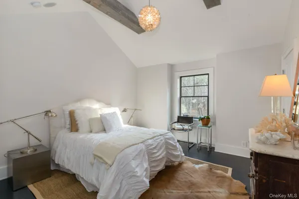 a bedroom with a bed and a table in it