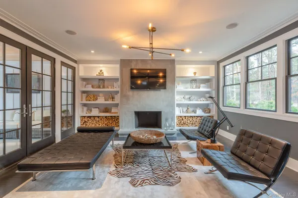 a living room with furniture a flat screen tv and a fireplace