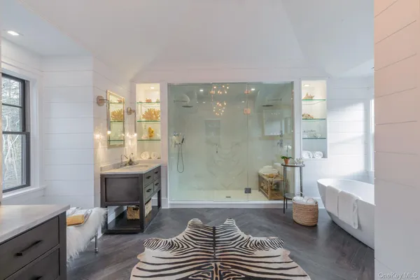 a bathroom with a sink a toilet a tub and shower