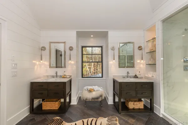 a room with a table chairs and chandelier