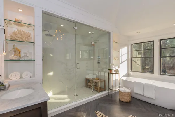 a bathroom with a granite countertop sink a toilet and shower