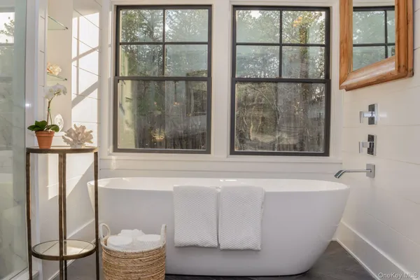 a white bath tub sitting next to a window