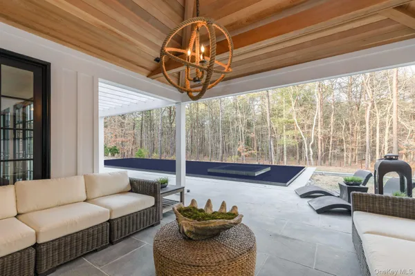 a living room with furniture and a chandelier