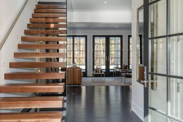 a view of entryway and hall with wooden floor