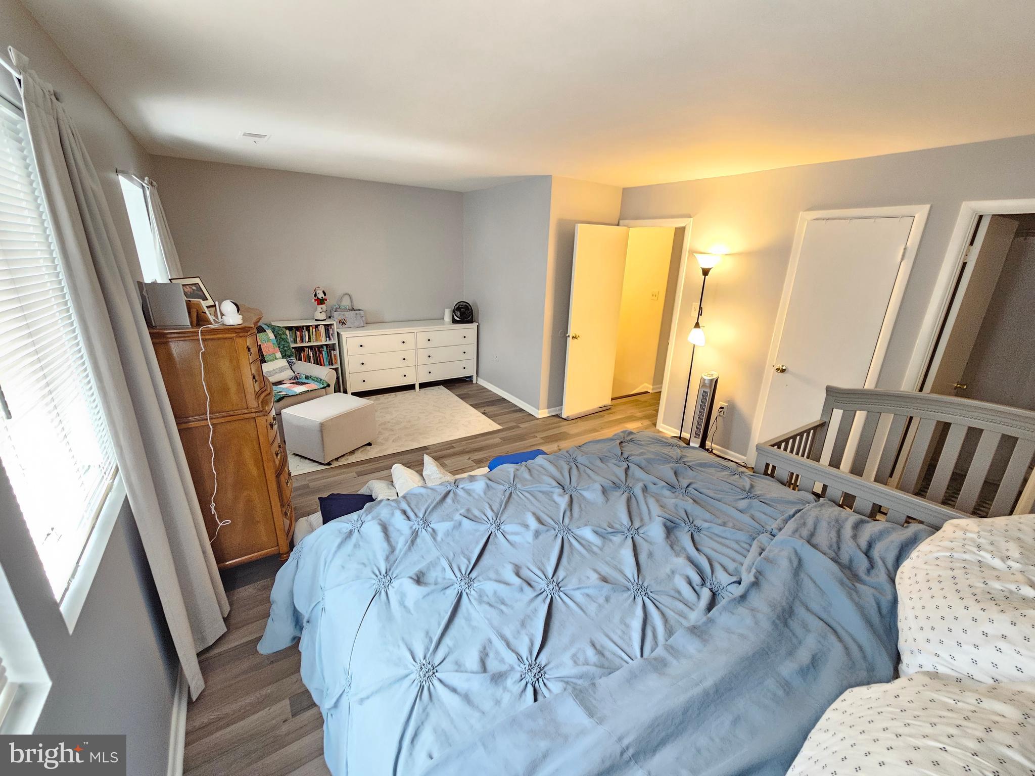 17445 Hoskinson Road Poolesville, MD 20837 - Photo 28 of 36 a bedroom with a bed and wooden floor