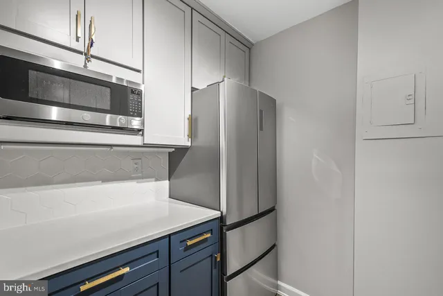 a kitchen with stainless steel appliances a refrigerator and cabinets