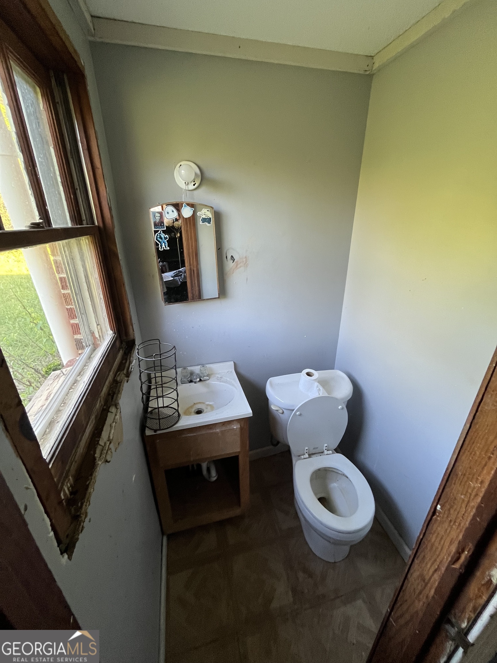 3658 West Point Road LaGrange, GA 30240 - Photo 5 of 7 a bathroom with a toilet sink and mirror