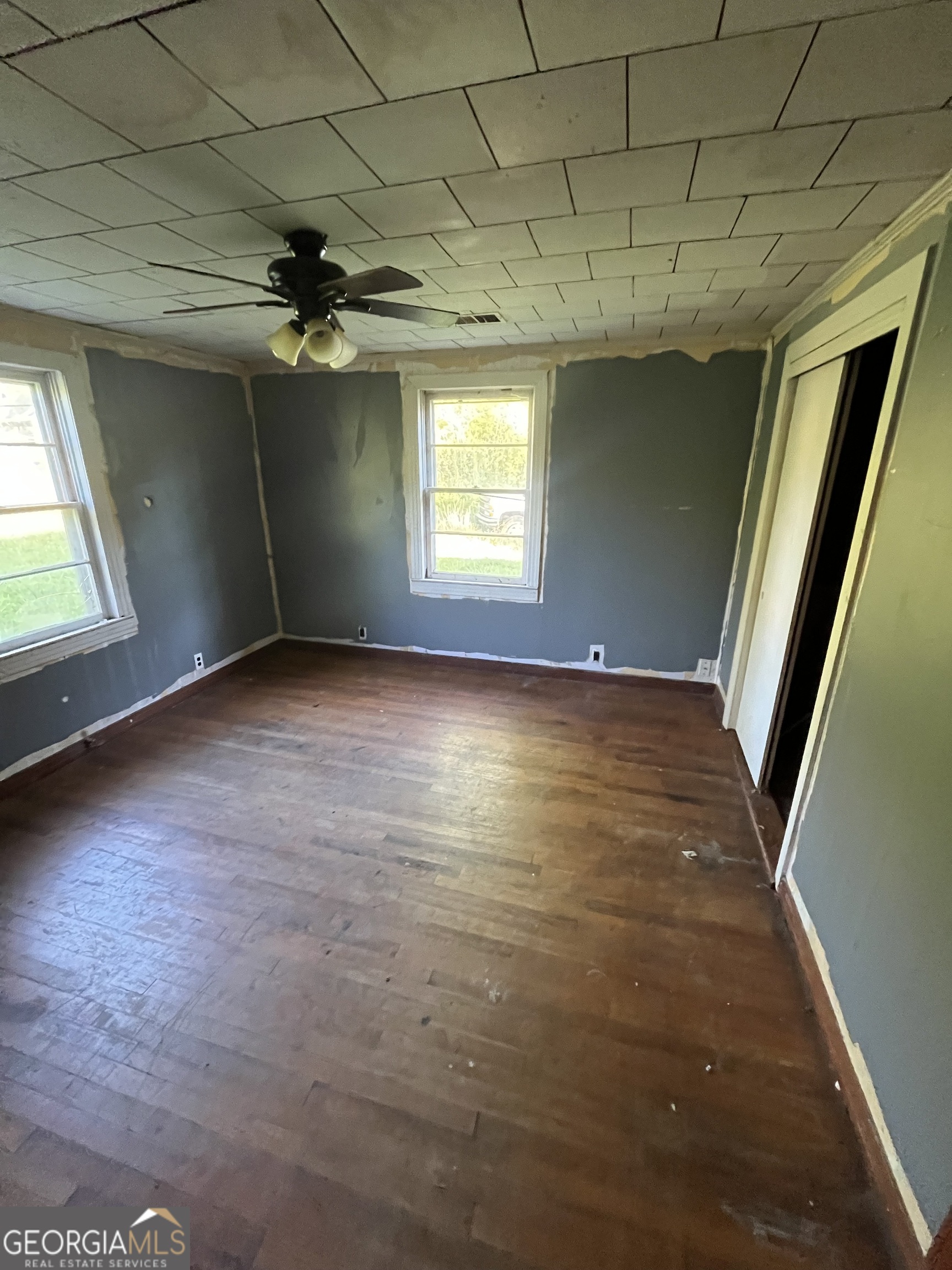 3658 West Point Road LaGrange, GA 30240 - Photo 6 of 7 en empty room with windows and ceiling fan