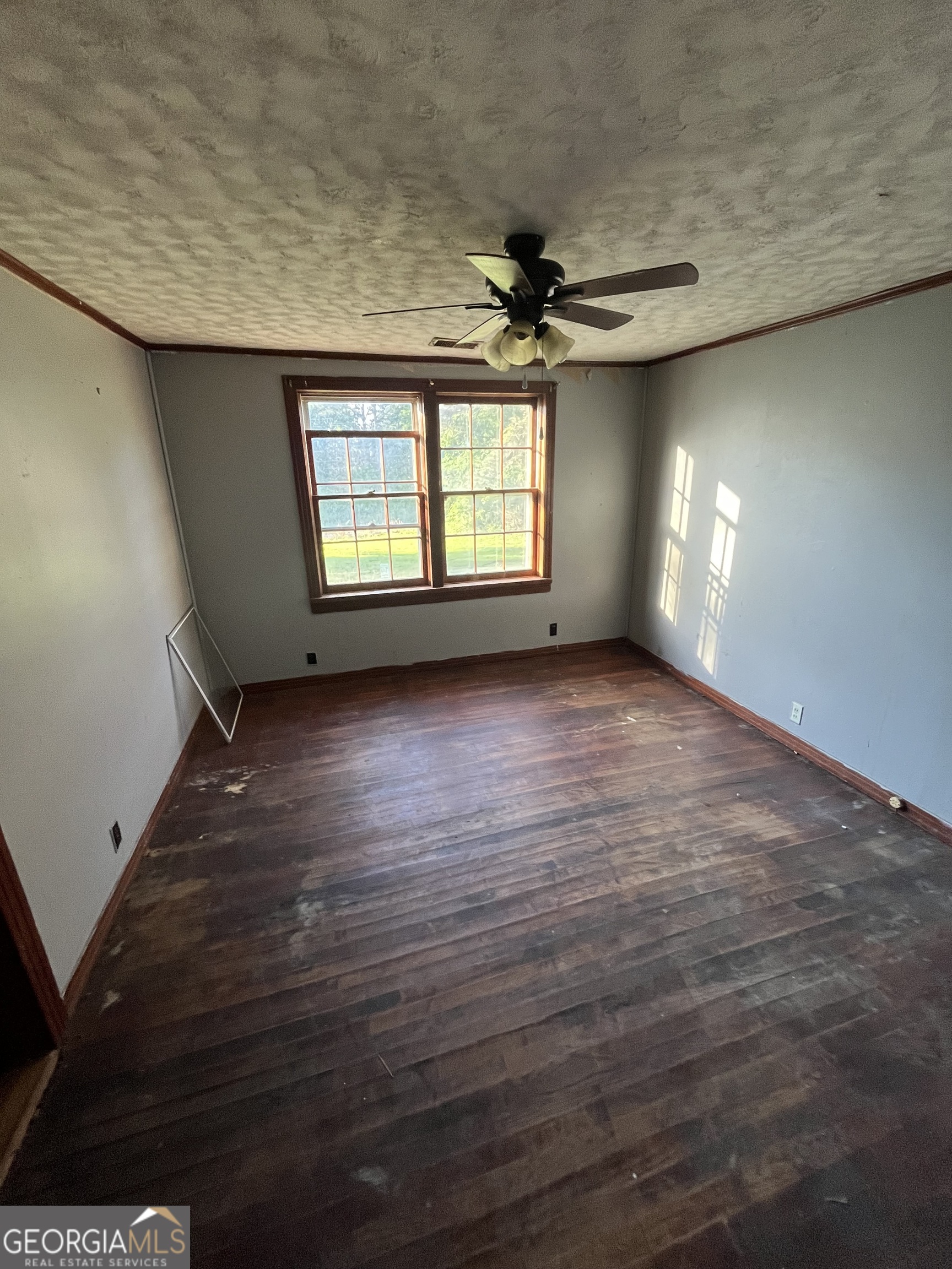 3658 West Point Road LaGrange, GA 30240 - Photo 7 of 7 en empty room with windows and ceiling fan