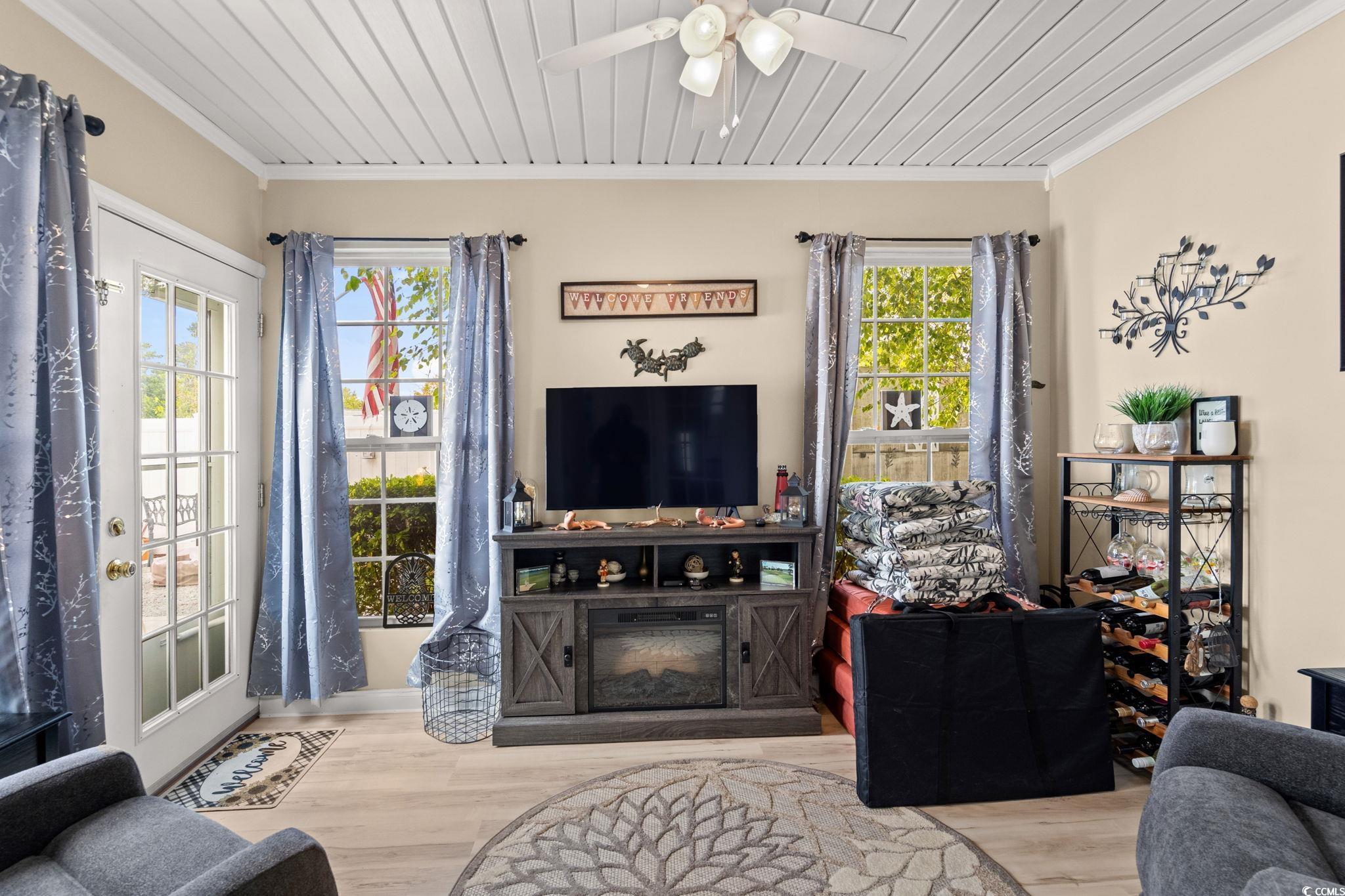 9533 Sullivan Drive Murrells Inlet, SC 29576 - Photo 18 of 40 Living room with ornamental molding, wooden ceiling, wood finished floors, and ceiling fan