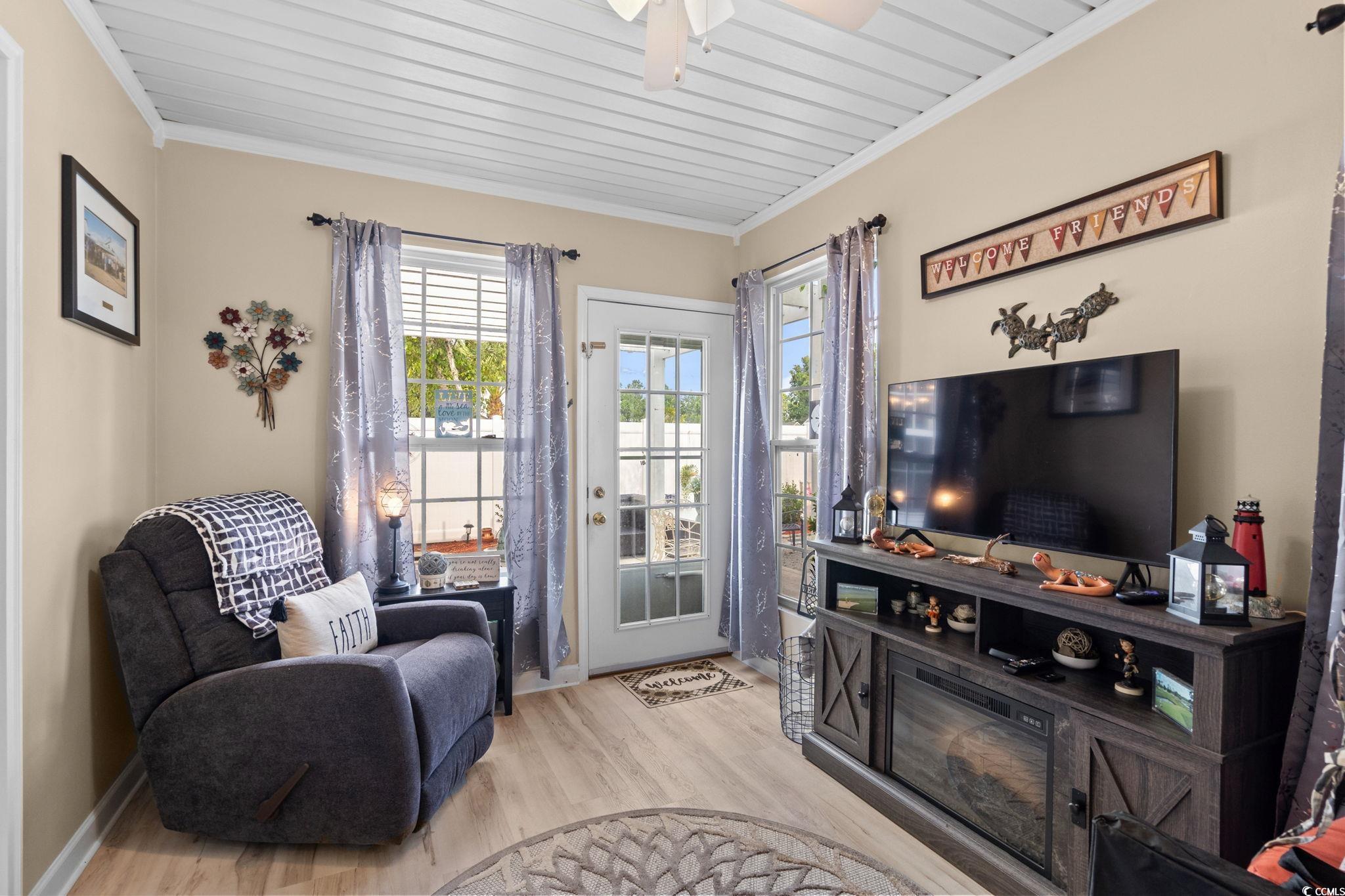 9533 Sullivan Drive Murrells Inlet, SC 29576 - Photo 20 of 40 Sitting room with ornamental molding, light wood-type flooring, and wood ceiling