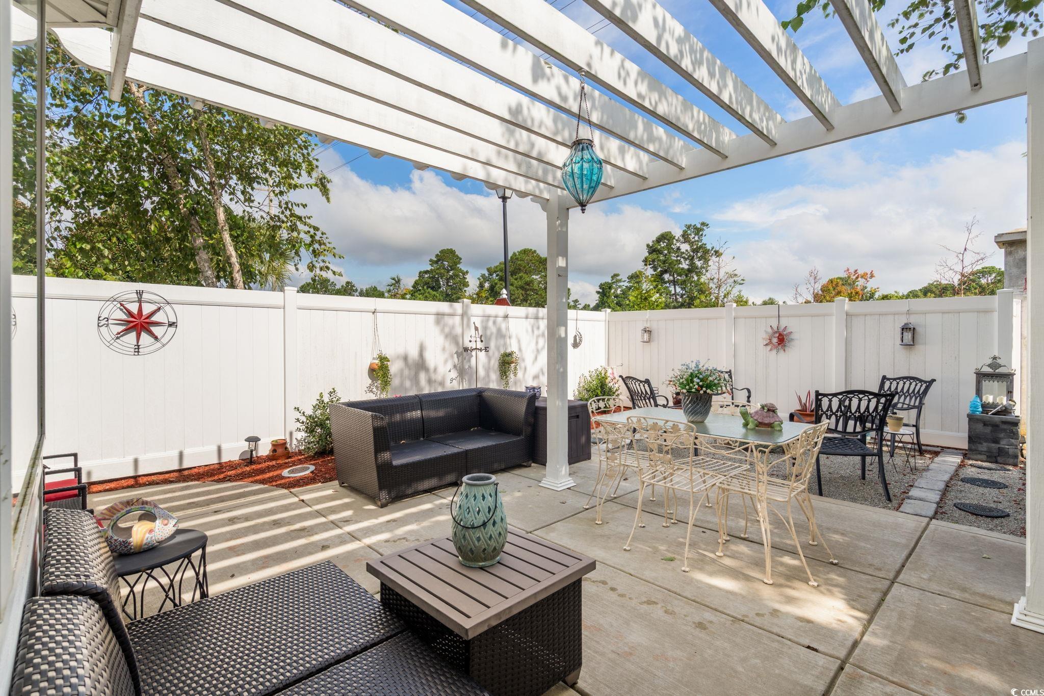 9533 Sullivan Drive Murrells Inlet, SC 29576 - Photo 21 of 40 Fenced backyard featuring an outdoor living space, a pergola, outdoor dining area, and a patio