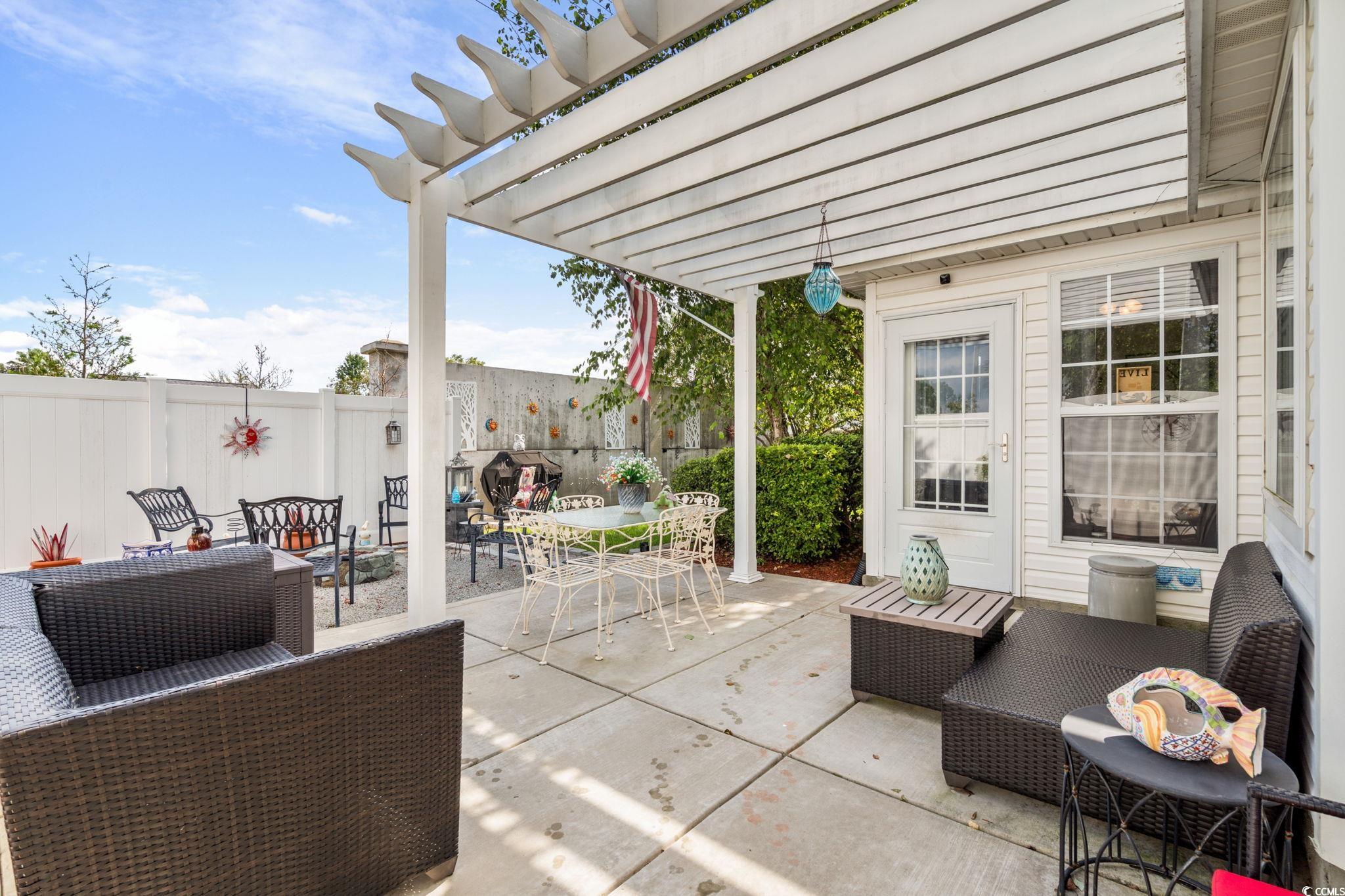 9533 Sullivan Drive Murrells Inlet, SC 29576 - Photo 23 of 40 Fenced backyard featuring an outdoor living space, a patio, a pergola, and outdoor dining area