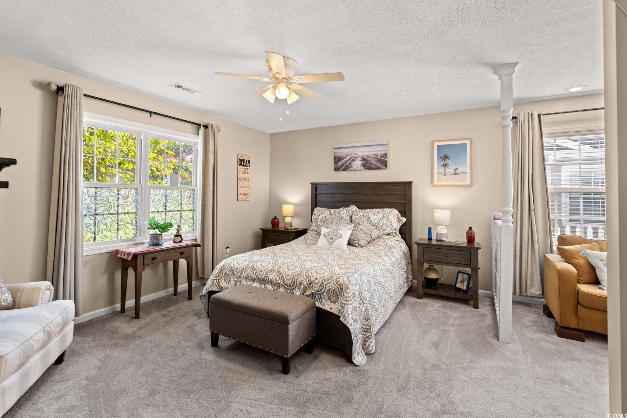 9533 Sullivan Drive Murrells Inlet, SC 29576 - Photo 28 of 40 Carpeted bedroom with ceiling fan and a textured ceiling