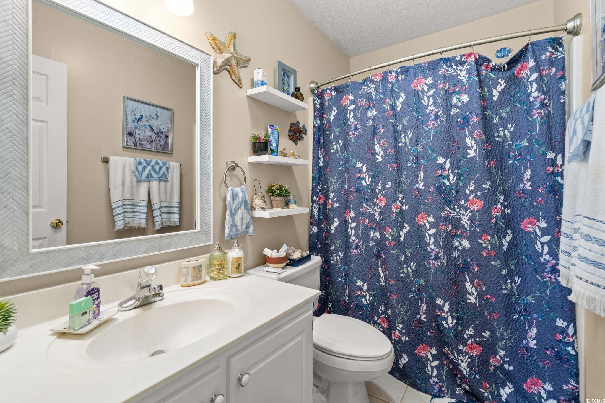9533 Sullivan Drive Murrells Inlet, SC 29576 - Photo 34 of 40 Full bath with vanity, tile patterned floors, and curtained shower