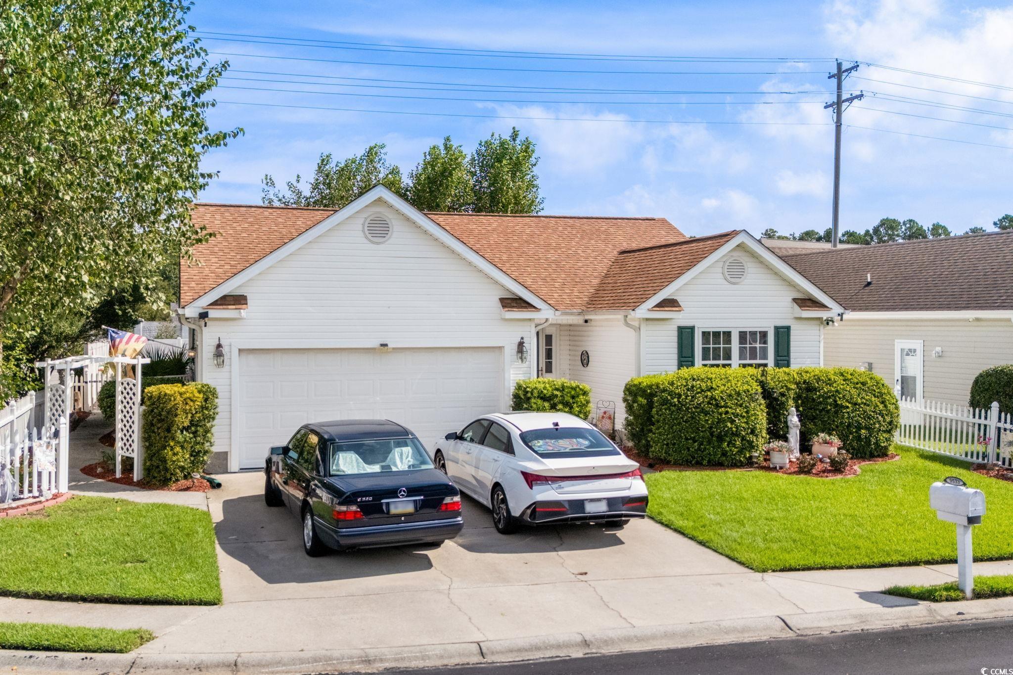 9533 Sullivan Drive Murrells Inlet, SC 29576 - Photo 4 of 40 View of front of home featuring a garage, driveway, and a shingled roof