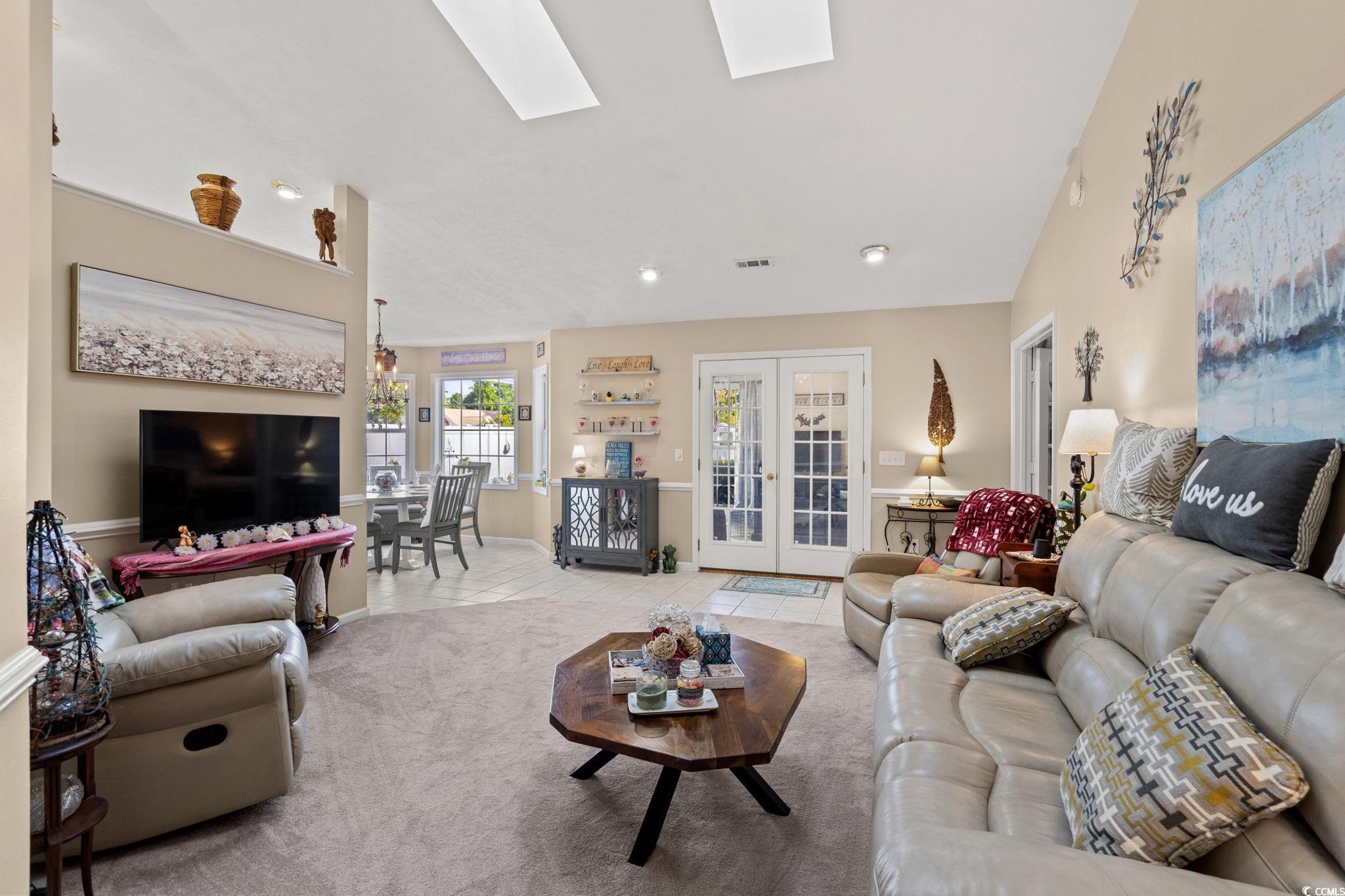 9533 Sullivan Drive Murrells Inlet, SC 29576 - Photo 6 of 40 Tiled living area with a skylight, french doors, and carpet