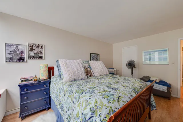 a bedroom with a bed and a dresser