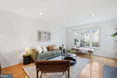 a living room with furniture wooden floor and a table