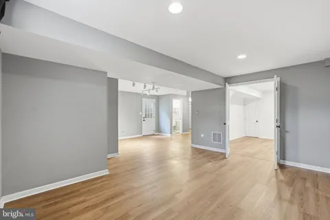 a view of an empty room with wooden floor