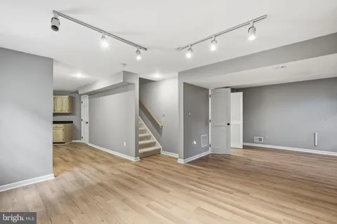 a view of an empty room with wooden floor