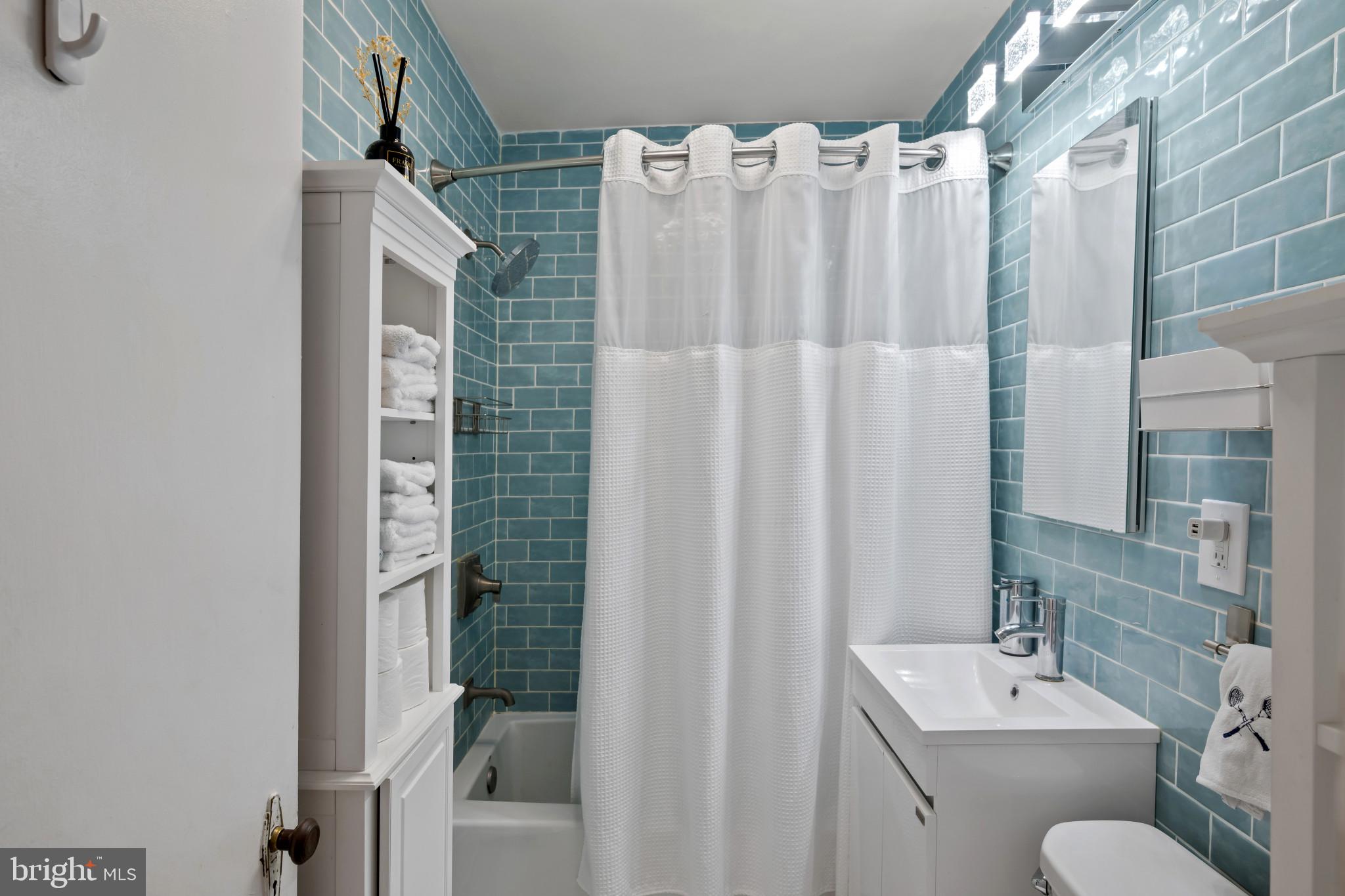 4235 Old Milford Mill Road Baltimore, MD 21208 - Photo 13 of 29 a bathroom with a shower curtain and a sink