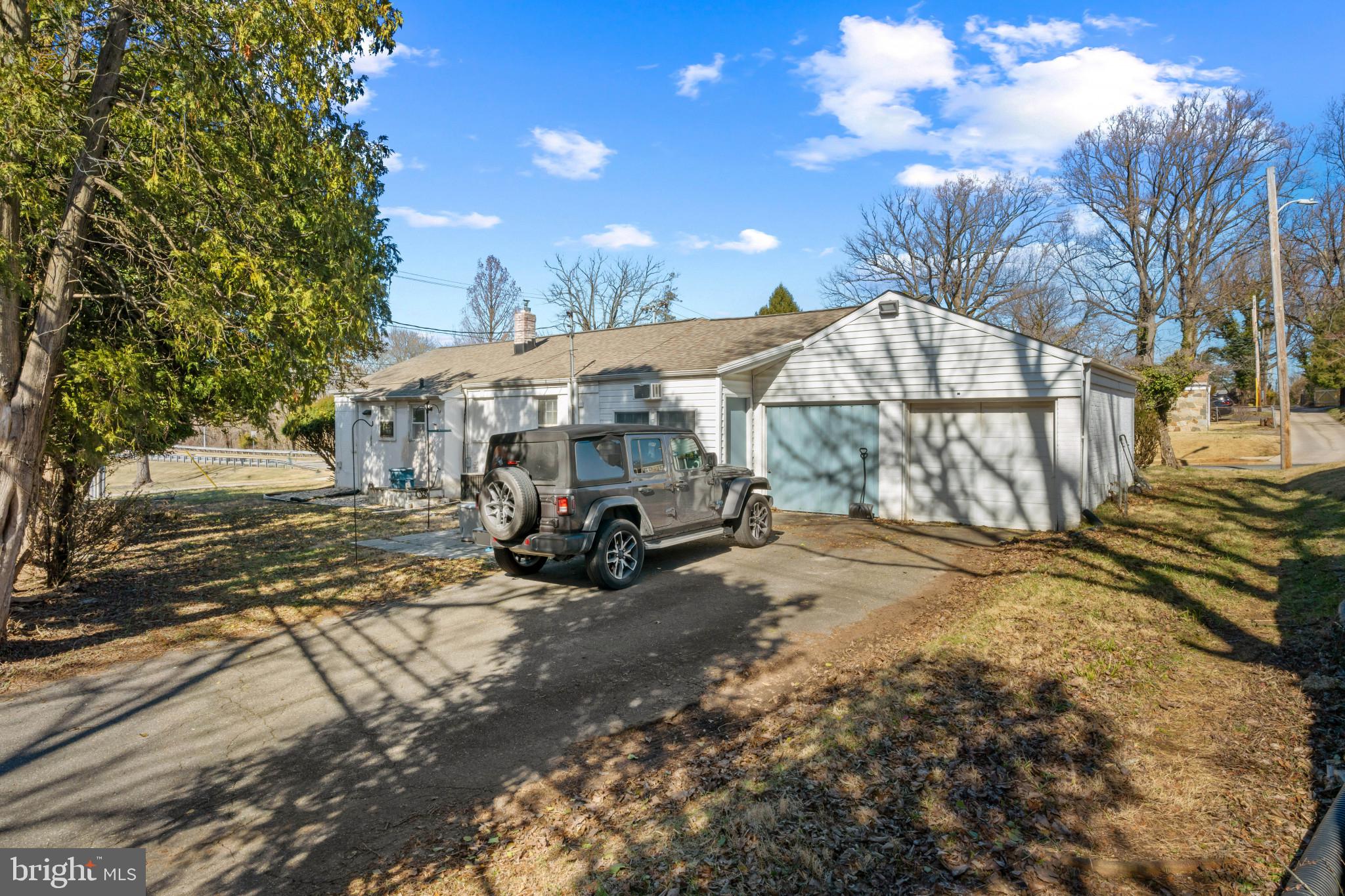 4235 Old Milford Mill Road Baltimore, MD 21208 - Photo 29 of 29 a view of a house with cars park next to a yard