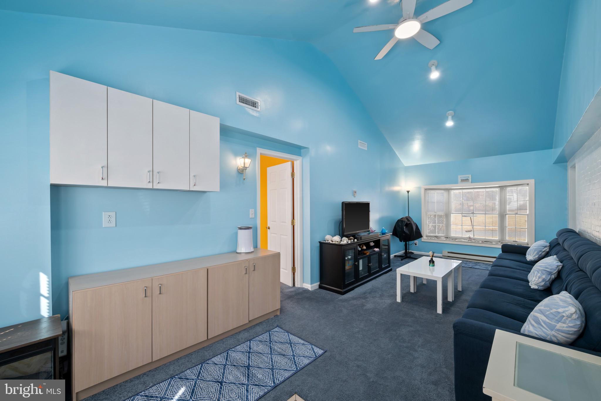 4235 Old Milford Mill Road Baltimore, MD 21208 - Photo 4 of 29 a living room with furniture a flat screen tv and kitchen view