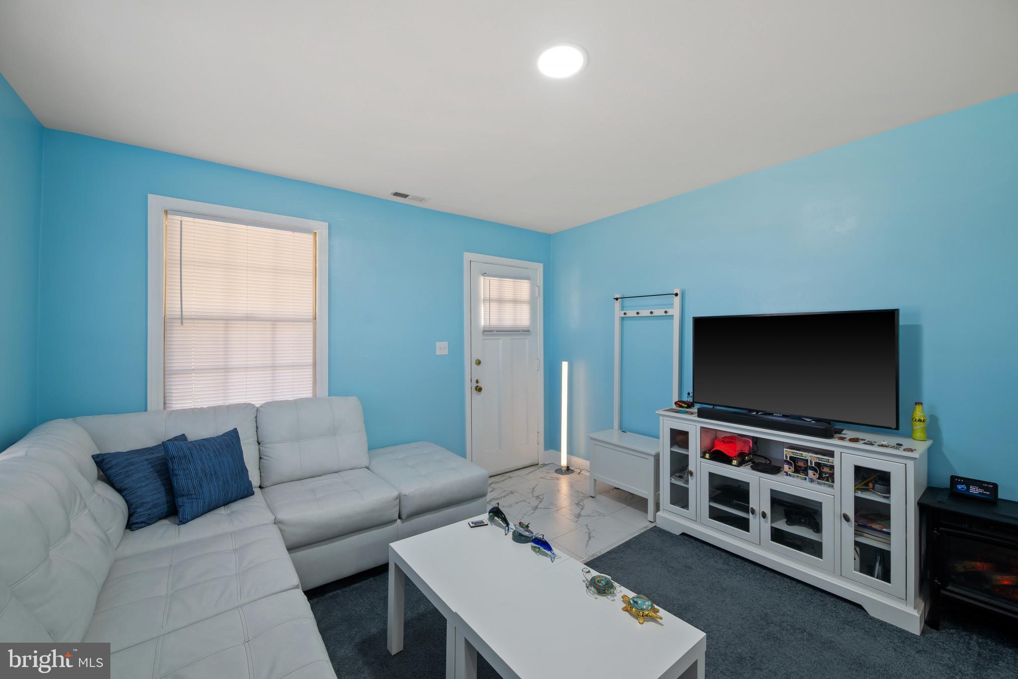 4235 Old Milford Mill Road Baltimore, MD 21208 - Photo 7 of 29 a living room with furniture and a flat screen tv