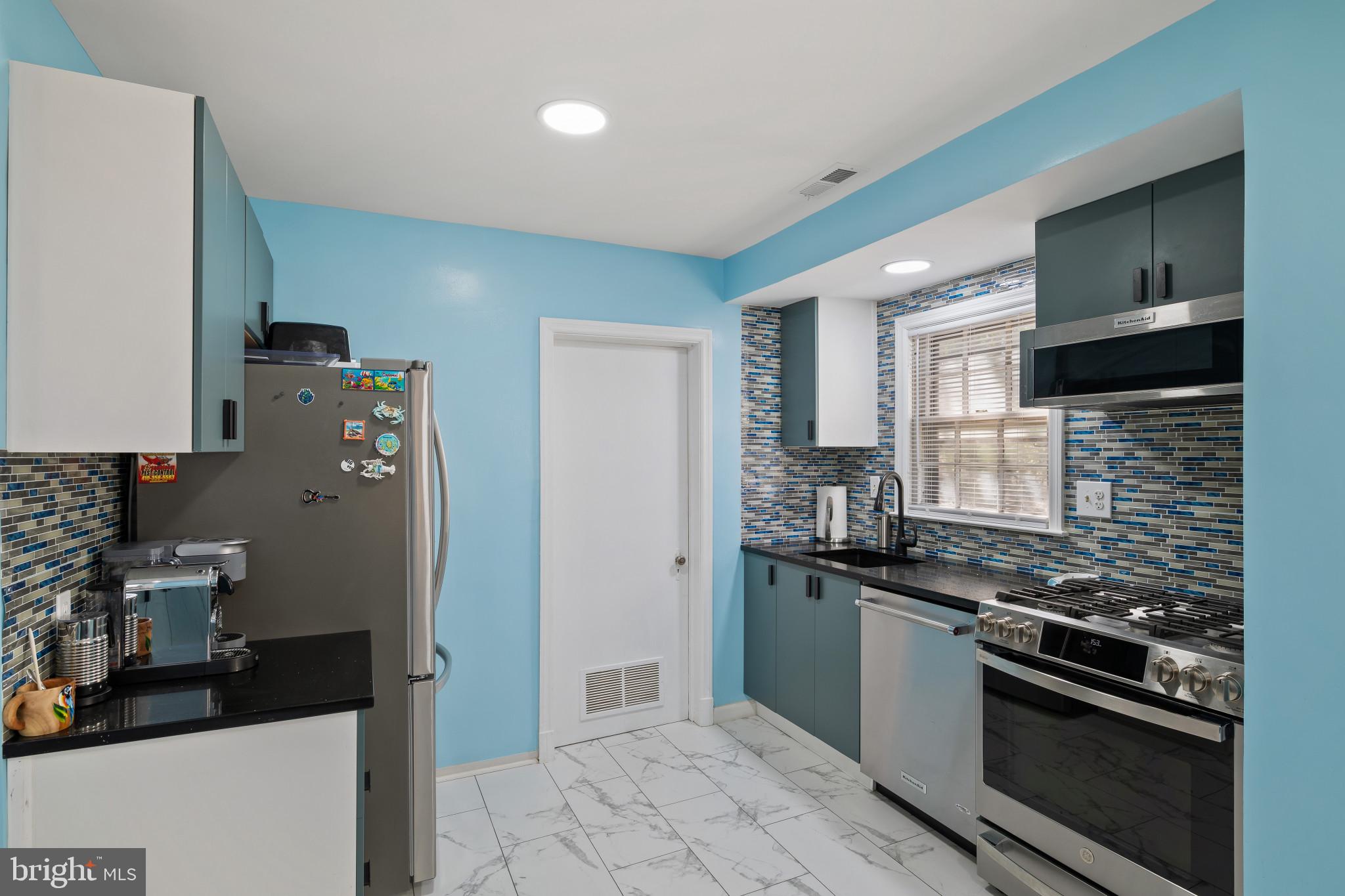 4235 Old Milford Mill Road Baltimore, MD 21208 - Photo 8 of 29 a kitchen with stainless steel appliances granite countertop a refrigerator and a stove top oven