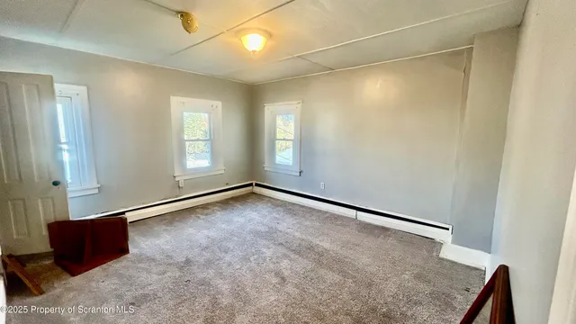 an empty room with a windows