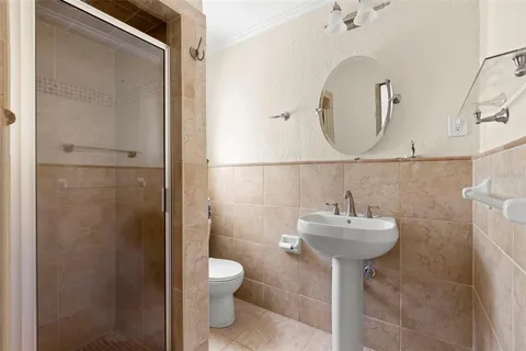 a bathroom with a sink toilet and a mirror