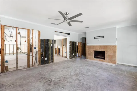 a view of a livingroom with a fireplace and a ceiling fan