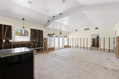 a large white kitchen with a large window