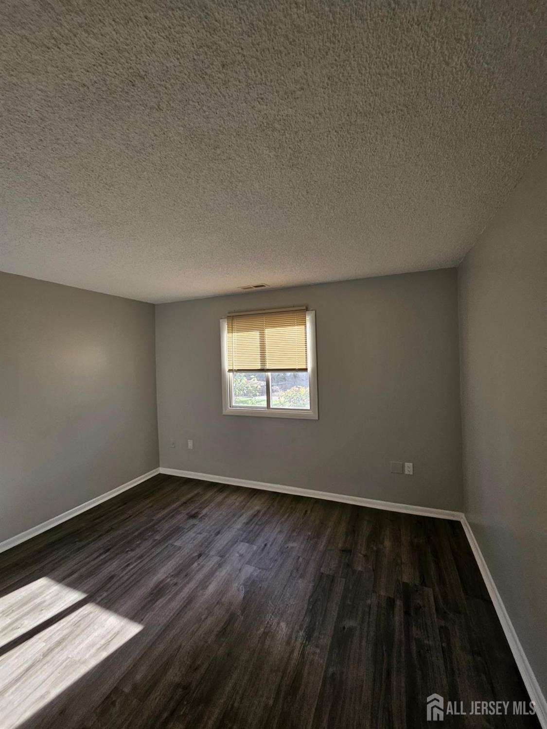 1503 Raspberry Court Edison, NJ 08817 - Photo 2 of 9 a view of an empty room and window