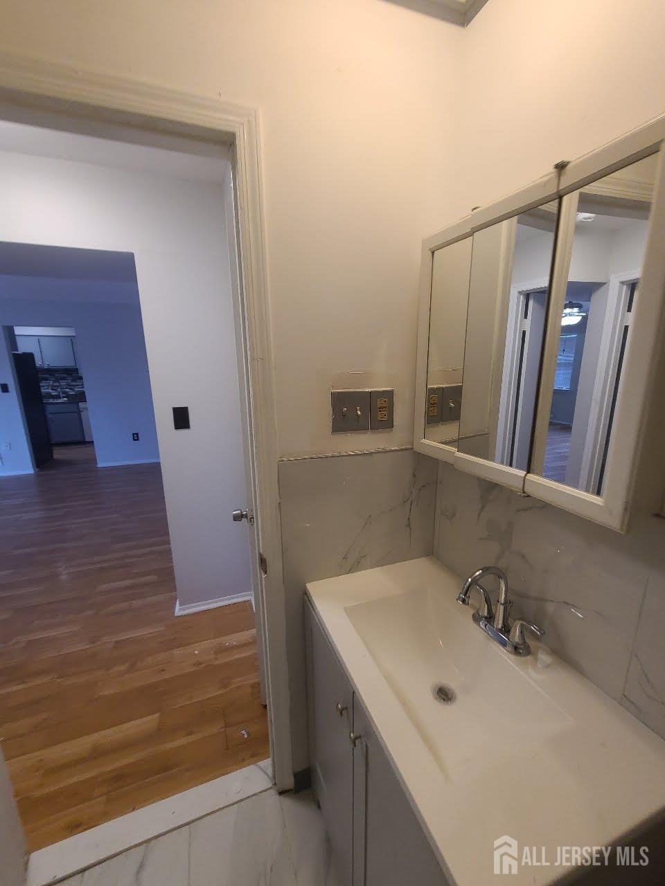 1503 Raspberry Court Edison, NJ 08817 - Photo 8 of 9 a bathroom with a sink and a mirror
