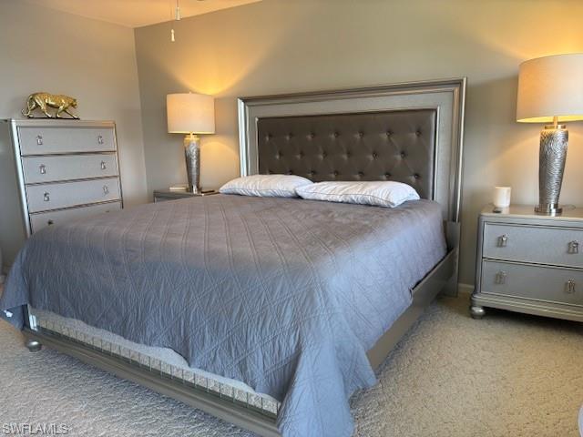 413 Augusta Boulevard, Unit 306 Naples, FL 34113 - Photo 13 of 31 a bedroom with a bed and a lamp on dresser