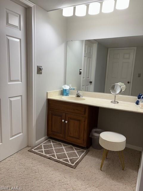 413 Augusta Boulevard, Unit 306 Naples, FL 34113 - Photo 15 of 31 a bathroom with a double vanity sink and a mirror